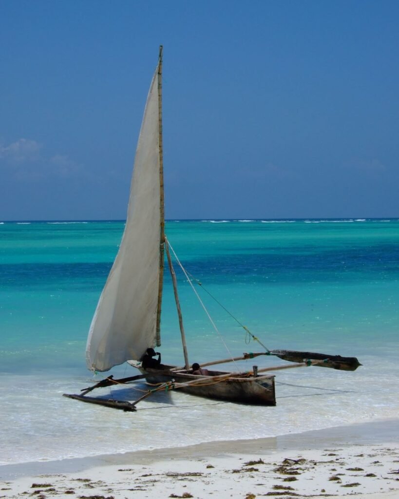 Traditional dhow boat on a white sand beach in Zanzibar Tanzania