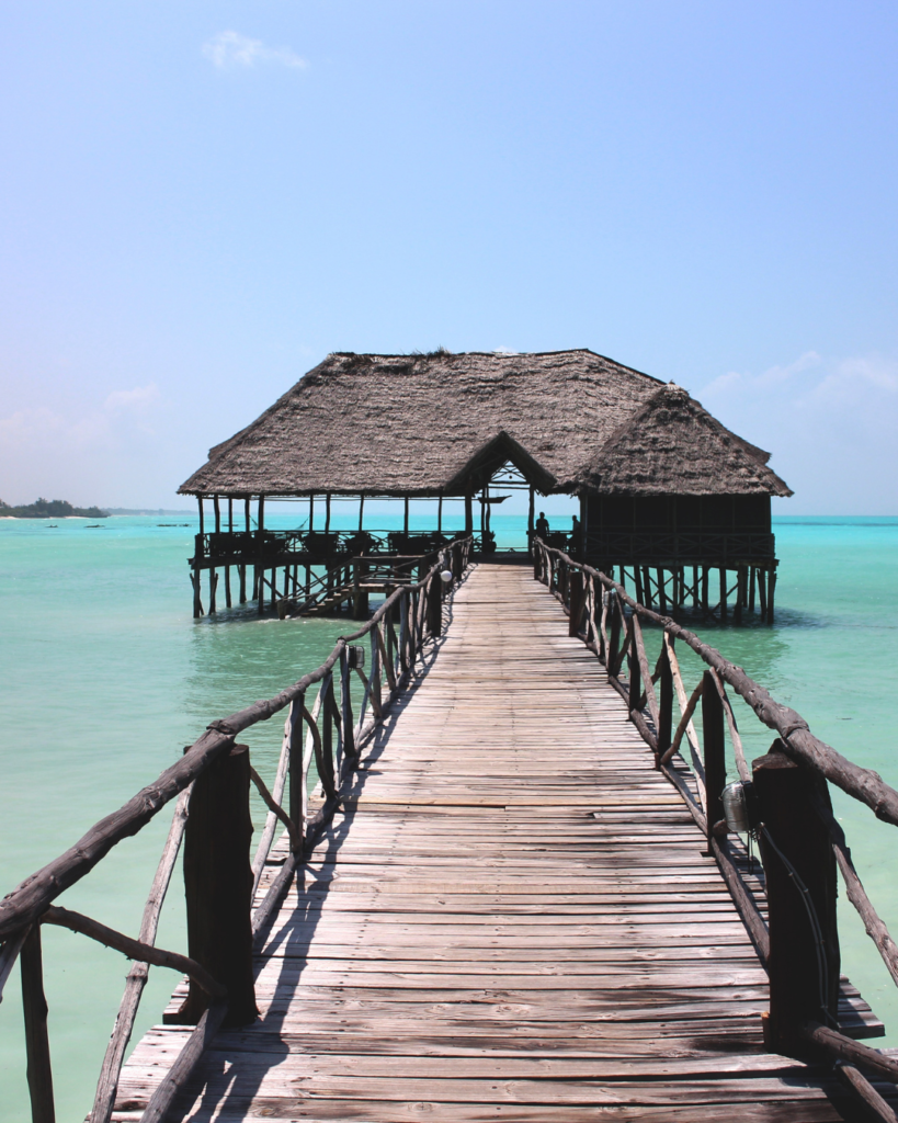 Zanzibar beach wooden walkway leading to ocean bungalow resort