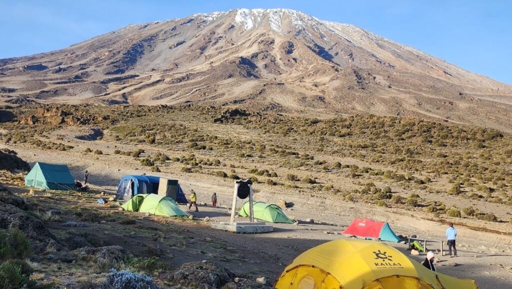 Climbers camping on the Mount Kilimanjaro Rongai Route with Mawenzi Peak in the background, Tanzania.