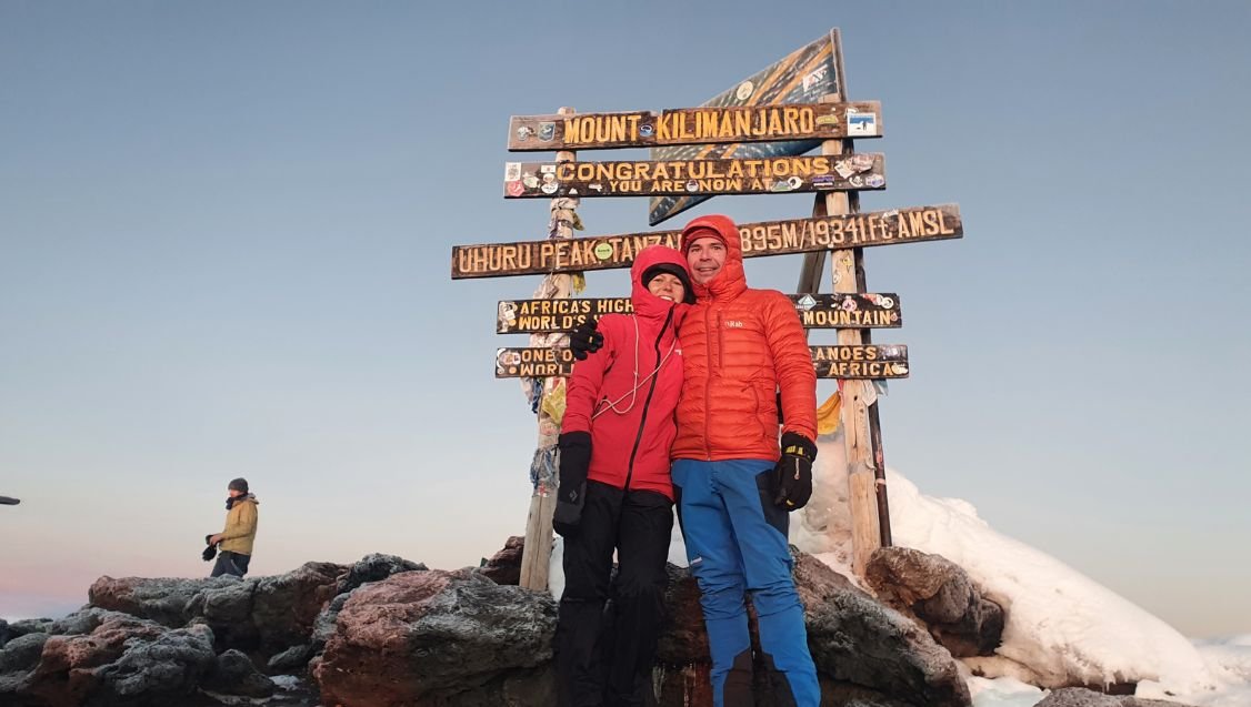 Climbers celebrating their Mount Kilimanjaro summit achievement